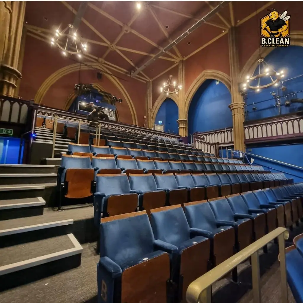 Channel 5s Brennan Budden of Filthy House SOS showcasing a theatre clean with tiered rows of blue chairs in historic building as part of commercial cleaning in Kent by B Clean Cleaning