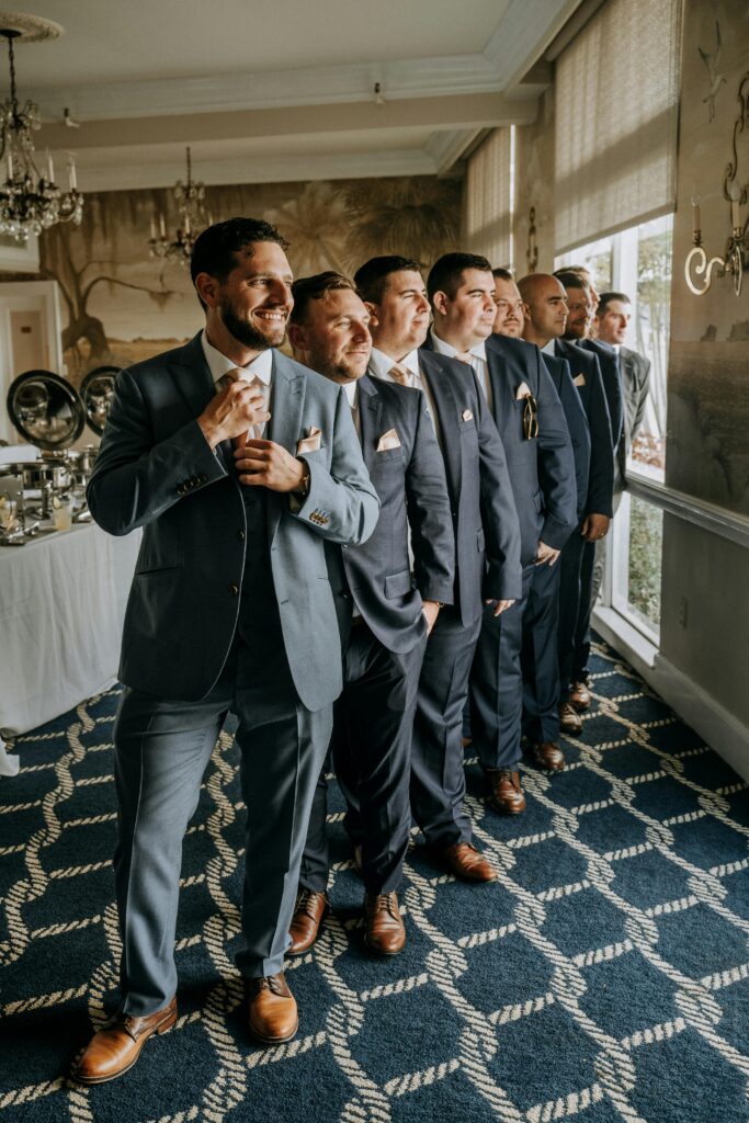 A group of men in suits enjoying a formal gathering in a stylish indoor setting on a clean blue carpet with rope design having had commercial cleaning in Kent by B Clean Cleaning